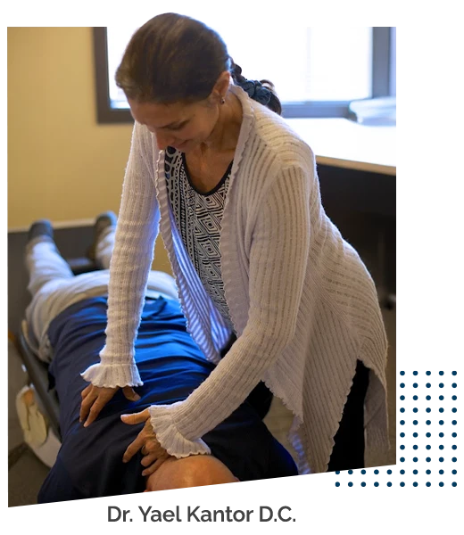 Chiropractor Burien WA Yael Kantor and Family Adjusting Patient